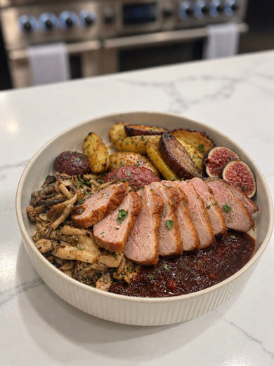 Sliced crispy-skin duck breast with Fig Serrano red wine reduction, roasted potatoes, mushrooms and fresh figs