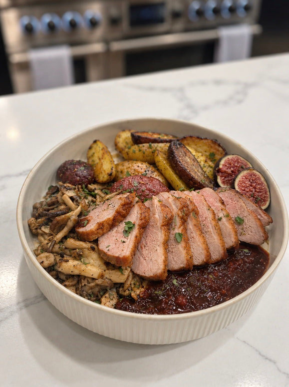 Sliced crispy-skin duck breast with Fig Serrano red wine reduction, roasted potatoes, mushrooms and fresh figs